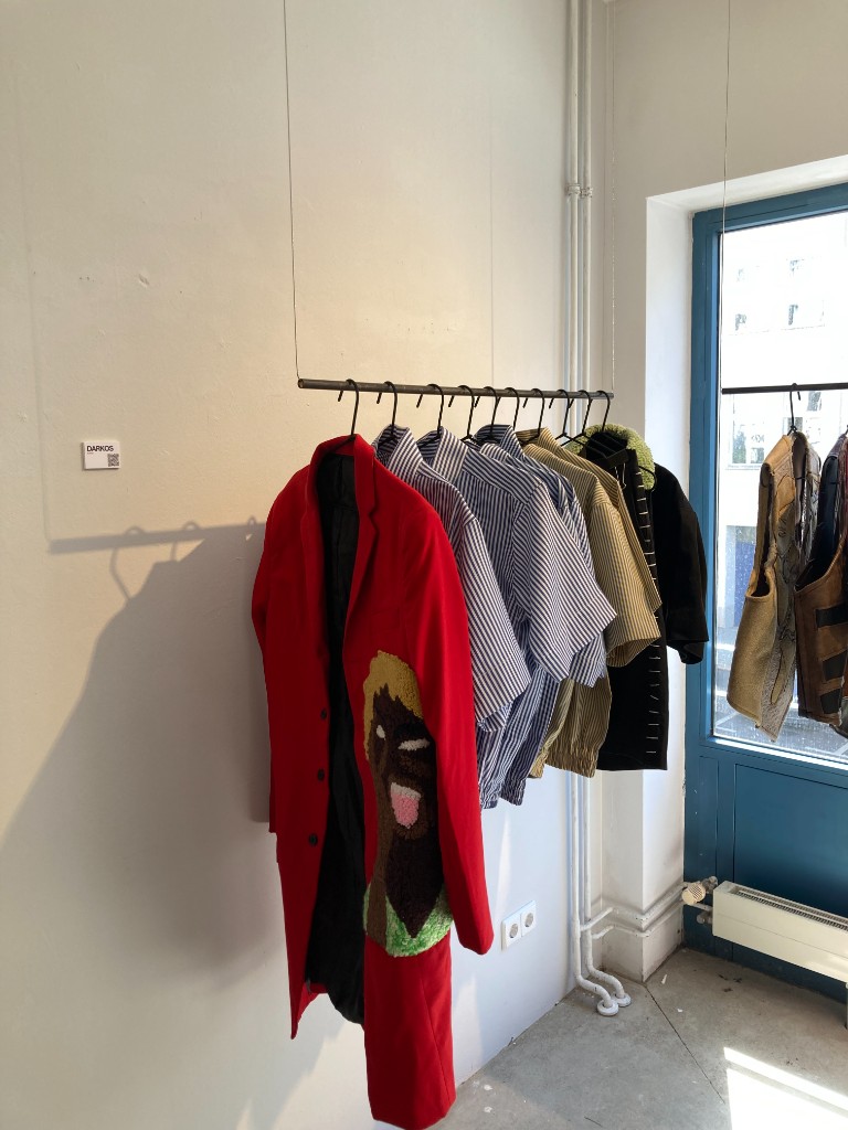 DARKOS pop-up display with red coat at Berlin Fashion Week